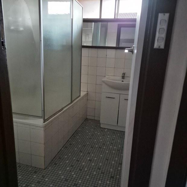 Bathroom with shower over bath after end of lease cleaning, Clayton South