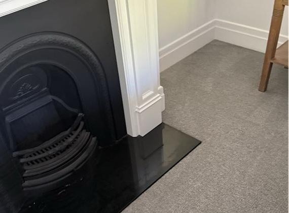 Freshly steam-cleaned carpet beside a period fireplace in Malvern, Melbourne