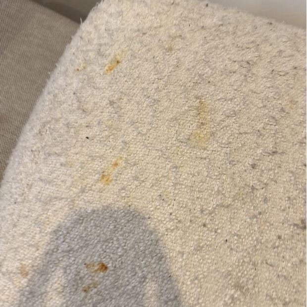 Spots on bouclé armchair seat before cleaning, Lower Plenty