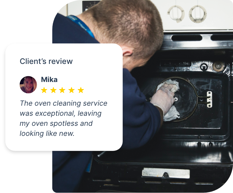 Technician cleaning an oven with specialized tools and cleaning solutions